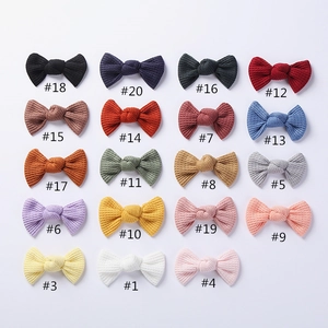 Flat lay of colorful waffle knit bow hair clips in 19 different winter colors
