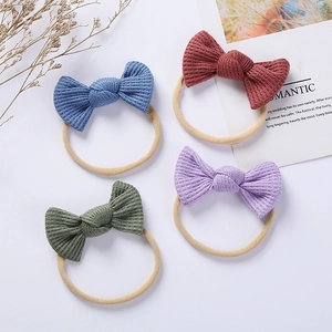 Detail of four colorful waffle texture bow headbands with soft elastic nylon bands for babies