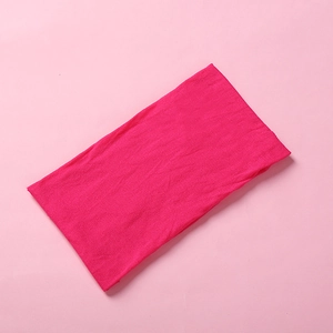 Close-up of soft rose red nylon headband showing fine knitted texture and elastic fabric
