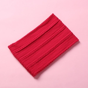 Detailed knit cable pattern on soft red winter neck warmer for babies and kids