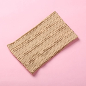 Detailed view of jacquard nylon headband with premium soft knitted texture and cable pattern