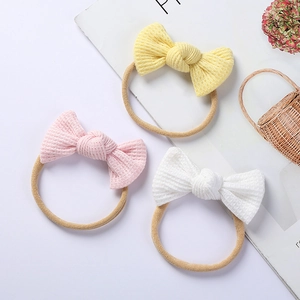 Three-piece baby bow headband set with waffle knit bows on soft nylon bands