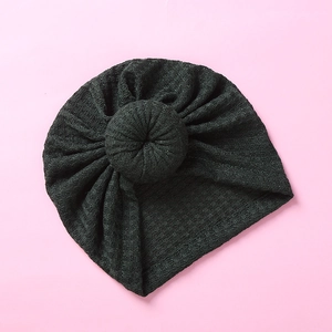 Detailed waffle knit texture and doughnut knot design on a dark gray baby turban hat