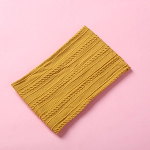 Detailed view of ginger yellow cable knit texture on soft nylon baby headband