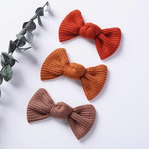 3-pack of knitted bow hair clips for baby girls in autumn warm tones with waffle texture