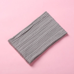 Close-up of grey cable knit texture and ribbed patterns on a soft baby nylon headband