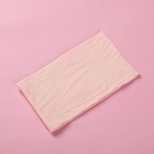 Detailed texture of light pink soft nylon baby headband showing fine fabric weaving