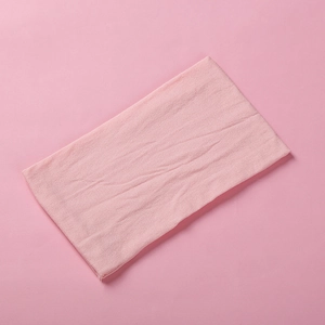 Close-up of pink soft nylon fabric texture with fine weave pattern for baby headbands