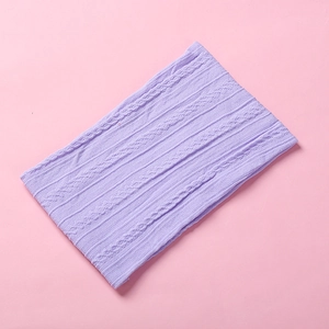 Close-up detail of light purple cable knit texture and soft nylon weave on baby headband