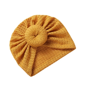 Ginger yellow waffle knit baby turban hat with a cute donut knot design for infants