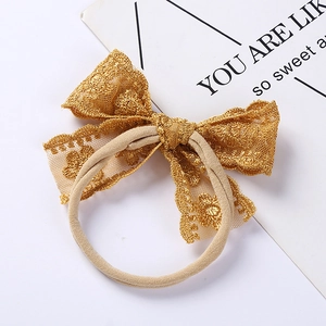 Soft nylon baby headband with delicate light gold lace embroidery butterfly bow detail