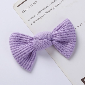 Detail of lavender waffle-knit bow hair clip for babies with soft textured fabric