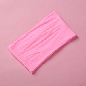 Detail shot of soft pink nylon headband featuring seamless ribbed knit texture for babies