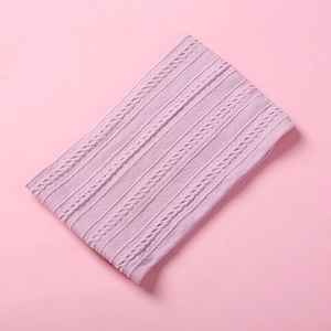Detailed view of soft light purple jacquard knitted nylon fabric with textured cable pattern