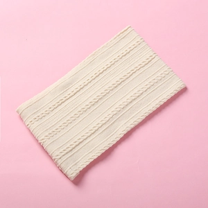 Close-up of cream cable-knit nylon baby headband fabric texture and soft weave detail