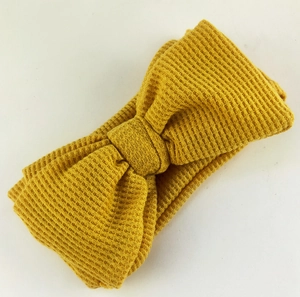 Elastic mustard yellow waffle knit headband with a large double layered bow for kids