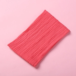 Detailed view of pink jacquard nylon baby headband with cable knit and ribbed texture