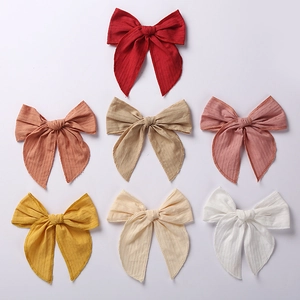 Set of 7 large 6-inch jacquard cotton bow hair clips in assorted warm and neutral colors