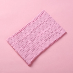 Macro shot of pink jacquard nylon headband with detailed cable knit texture and soft fabric