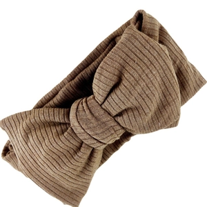 Elastic waffle knit headband for babies with a large double-layered brown bow tie knot