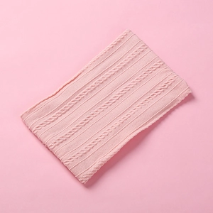 Detail of soft pink jacquard nylon fabric with classic cable-knit texture for baby headbands