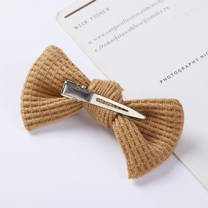 Detail of camel waffle knit bow hair clip with silver metal alligator clip attachment