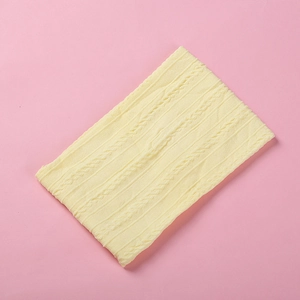 Close-up of baby beige cable knit nylon headband showing soft jacquard texture