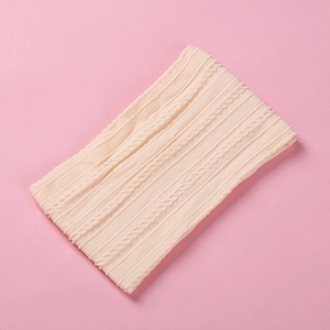 Close-up of soft jacquard nylon baby headband with intricate cable knit texture details
