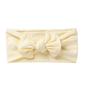 Elastic cream yellow ribbed knit baby headband with a large bow decoration for infants