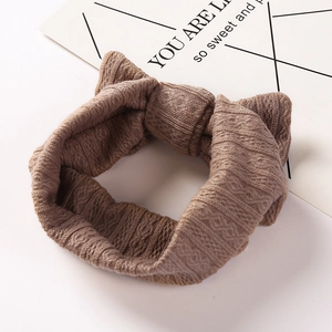 Knitted waffle texture baby headband with a large bow in elegant caramel brown color