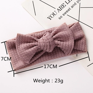 Detail view of 17x7cm ribbed knit baby headband with bow in dusty pink shade