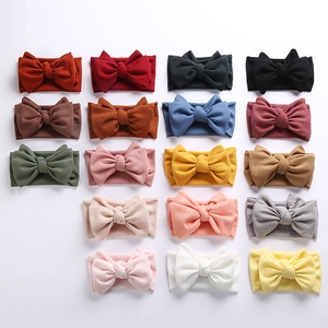 Assorted colors of waffle knit baby headbands with large double bows in grid layout