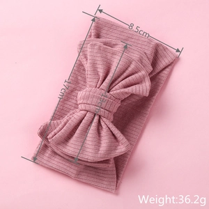 Detailed size specifications of pink knitted ribbed baby headband with oversized bow