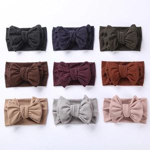 Detailed grid showing nine colors of ribbed knit baby headbands with oversized bows