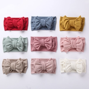 Detailed grid showing nine colorful ribbed knit headbands with large bow accents for kids