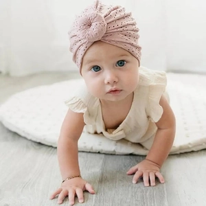 Detail of baby turban hat in pink purple hollow lace fabric with soft knotted design