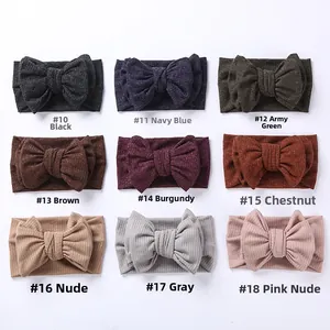 Nine colors of ribbed knit baby headbands with oversized double-layer bows in a grid layout