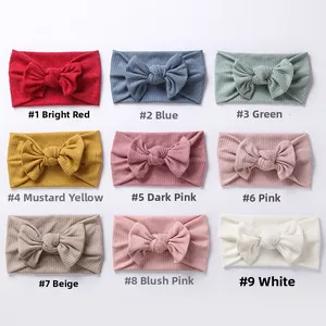 Detailed grid of ribbed baby headbands featuring soft fabric and large bows in nine colors