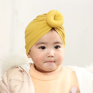 Bright yellow ribbed knit baby turban hat featuring a decorative 3D donut knot detail
