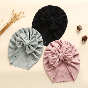 Lace eyelet baby turban hats with large bows in black, sage green, and dusty pink