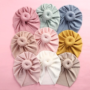 Baby turban hat set featuring elastic ribbed knit fabric with stylish donut knot detail