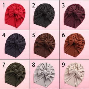 Detailed grid showing nine colors of ribbed knit baby turban hats with large bows