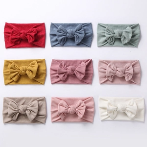 9-piece set of soft ribbed knit baby headbands with large bows in assorted colors