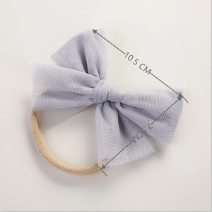 Detail view of a 10.5cm soft purple tulle bow on a high elasticity nylon baby headband