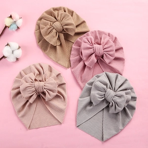 Soft ribbed baby turban hats with large bows in khaki, pink, nude pink, and gray colors