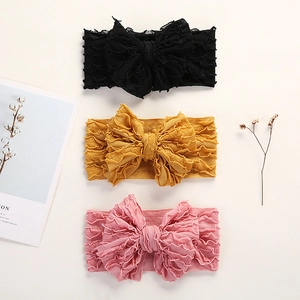 Lot de trois bandeaux élastiques pour bébé avec grands nœuds en noir, moutarde et rose