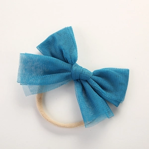 Detail of baby soft mesh bow headband in peacock blue with high-elastic nylon band