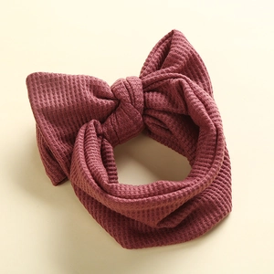 Sweet burgundy waffle knit baby headband with a large bow for infants and toddlers