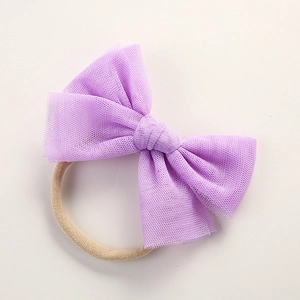 Detail of light purple layered mesh bow on soft nude nylon baby headband for infants
