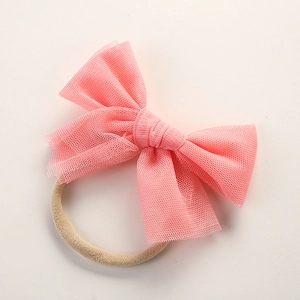 Detail view of the layered mesh pink bow and high-elastic nylon baby headband material